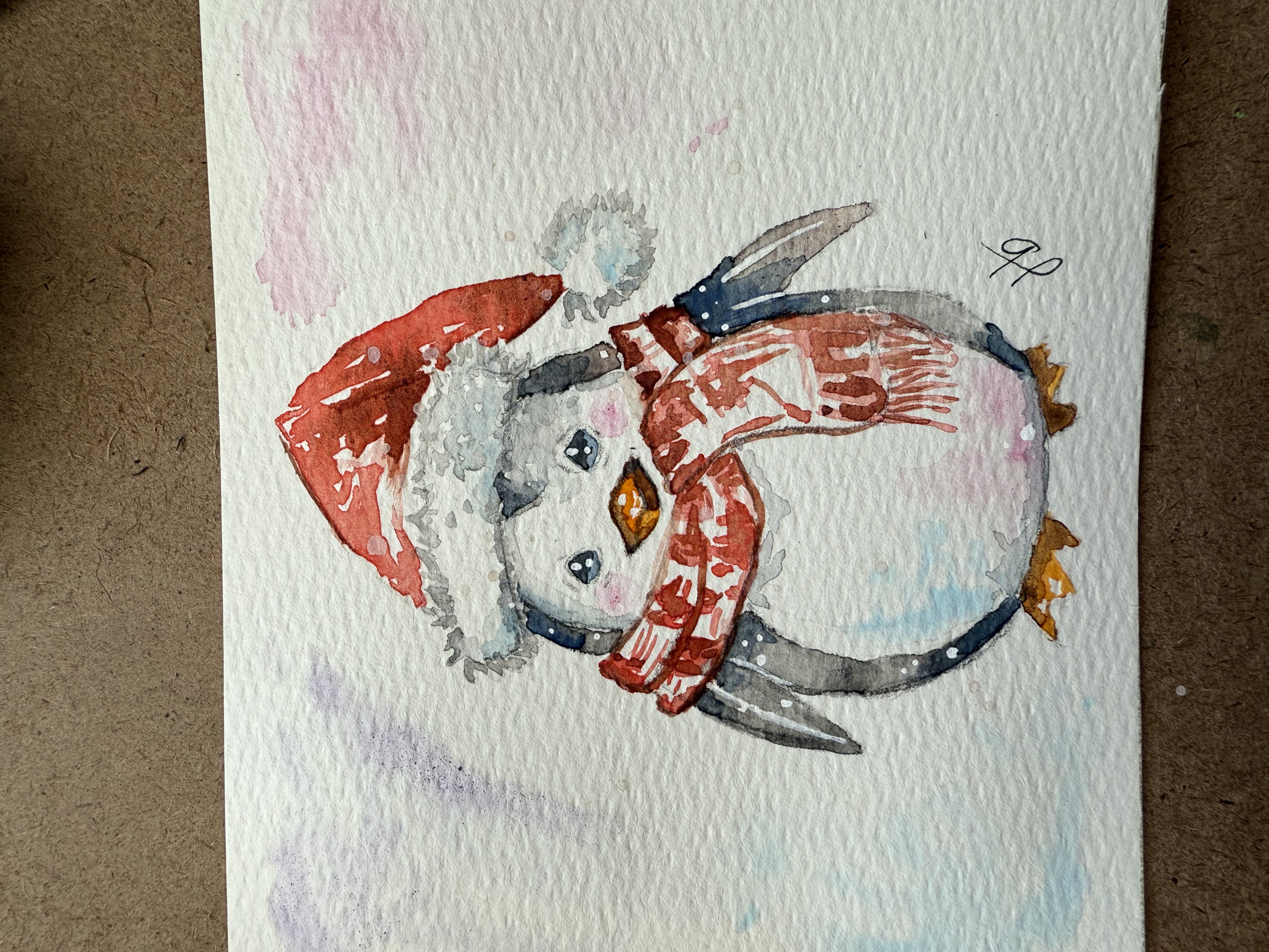 Loose watercolor of a penguin wearing a Santa hat and red scarf