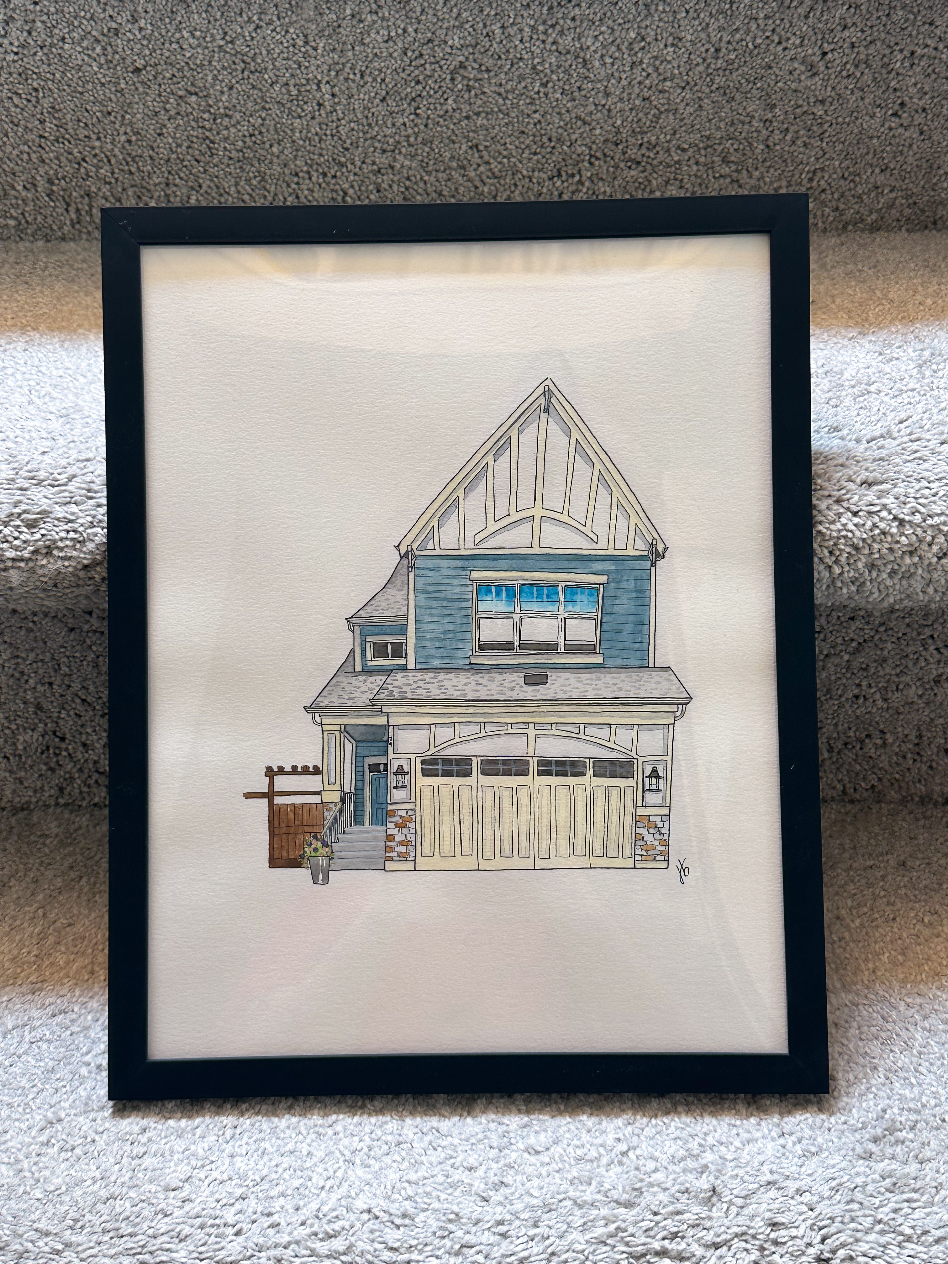 Framed watercolor of a two-storey craftsman home with blue siding and a garden gate