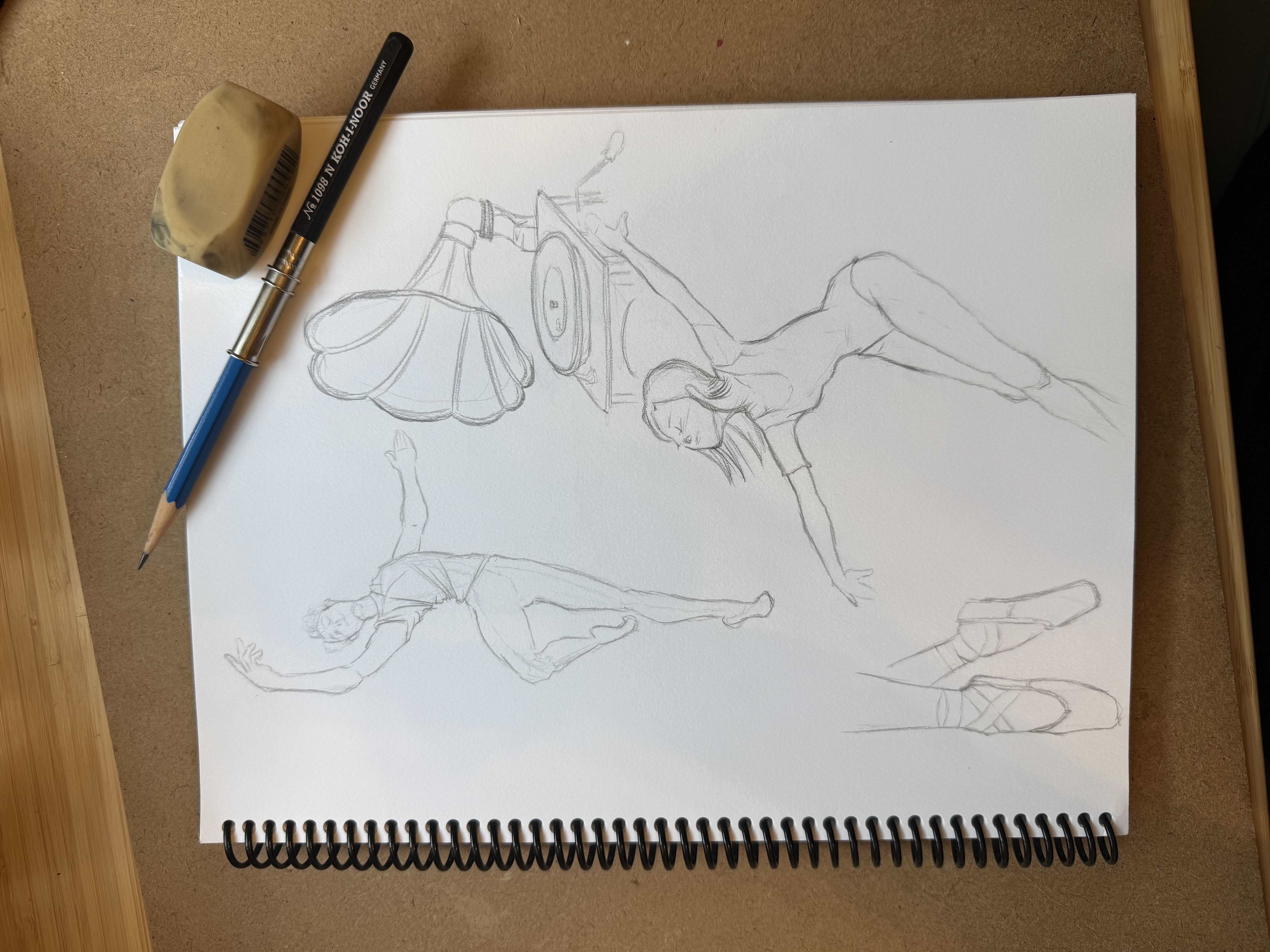 Pencil sketchbook page of figure studies with reclining and gestural poses