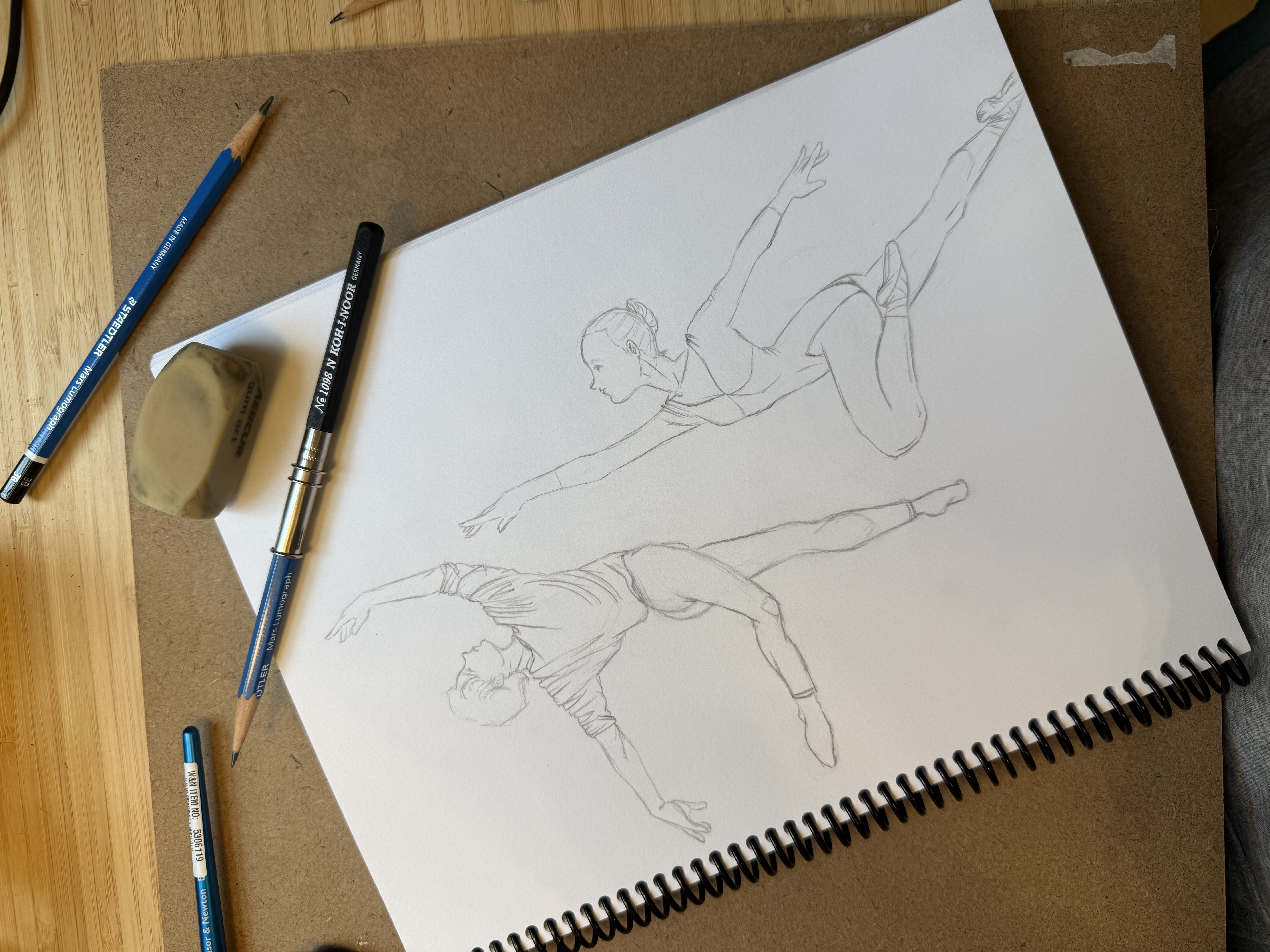 Pencil sketchbook page of dancers leaping and balancing in dynamic poses